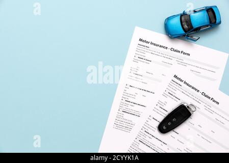 Car insurance, insurance contract and car keys on a blue background Stock Photo