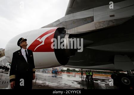 Qantas Airways pilot Captain Richard Champion de Crespigny stands in front of the replaced number 2 Rolls Royce Trent 900 engine of the repaired Qantas A380 VH-0QA passenger jet on the tarmac of Singapore's Changi Airport April 21, 2012. One of the four Trent 900 engines of the aircraft suffered a mid-air engine explosion in November 2010 shortly after takeoff from Singapore. After a A$139 million ($143.72 million) repair bill, 90,000 production hours and 18 months later, Qantas will fly the plane, named after Australia's aviation pioneer Nancy Bird-Walton, to Sydney from Singapore on Saturday