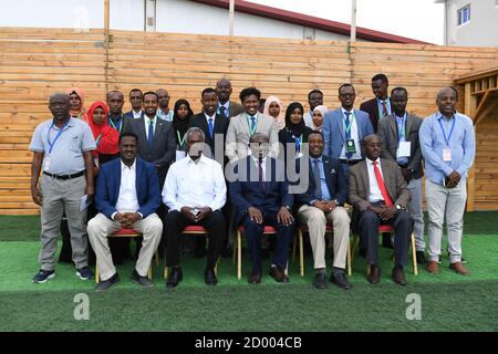 Senior officials of Somalia's Federal Ministry of Foreign Affairs and International Cooperation and facilitators pose for a photo with participants at the end of a training on Media and Communication Strategy Development in Mogadishu on November 25 2019. The training was organized with the support of the African Union Mission in Somalia (AMISOM). Stock Photo