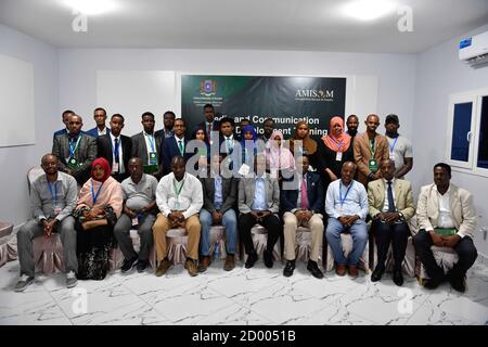 Senior officials of Somalia's Federal Ministry of Foreign Affairs and International Cooperation and facilitators pose for a photo with participants  at the end of a training on Media and Communication Strategy Development in Mogadishu on November 25 2019. The training was organized with the support of the African Union Mission in Somalia (AMISOM). Stock Photo