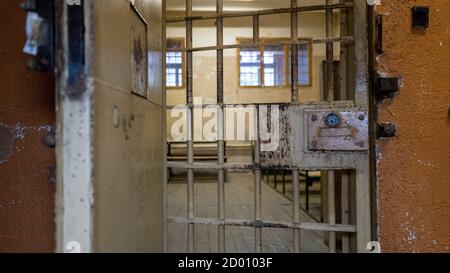 Light Coming in Through Prison Cell Bars Window. Empty Jail Cells. Prison Interior. Concept of Limiting Freedom. Stock Photo