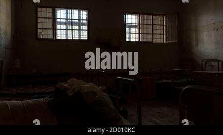 Light Coming in Through Prison Cell Bars Window. Jail Cells. Prison Interior. Concept of Limiting Freedom. Stock Photo