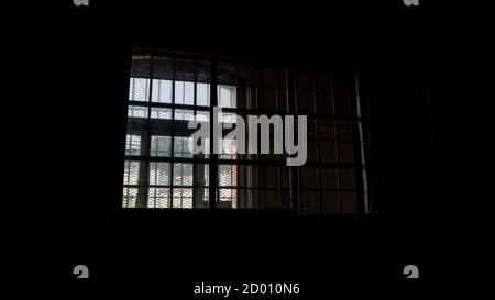 Light Coming in Through Prison Cell Bars Window. Empty Jail Cells. Prison Interior. Concept of Limiting Freedom. Stock Photo