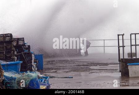 Newquay,Cornwall, 2nd October 2020. UK Weather: Storm Alex generates huge waves in the west country. Overwhelming the harbour. Young men are soaked by the waves at Newquay Harbour, Newquay Cornwall.  Credit: Robert Taylor/Alamy Live News Stock Photo