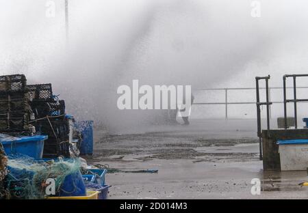 Newquay,Cornwall, 2nd October 2020. UK Weather: Storm Alex generates huge waves in the west country. Overwhelming the harbour. Young men are soaked by the waves at Newquay Harbour, Newquay Cornwall.  Credit: Robert Taylor/Alamy Live News Stock Photo