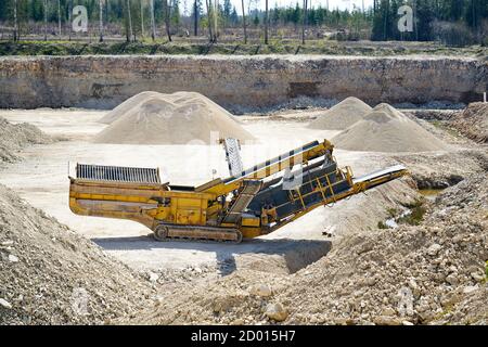 Mechanical machine, conveyor belt for transporting and crushing stone with sand. Mining quarry for the production of crushed stone, sand and gravel fo Stock Photo