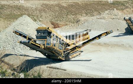 Mechanical machine, conveyor belt for transporting and crushing stone with sand. Mining quarry for the production of crushed stone, sand and gravel fo Stock Photo