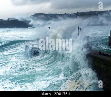 Newquay,Cornwall, 2nd October 2020. UK Weather: Storm Alex generates huge waves in the west country. Overwhelming the harbour. Young men are soaked by the waves at Newquay Harbour, Newquay Cornwall.  Credit: Robert Taylor/Alamy Live News Stock Photo