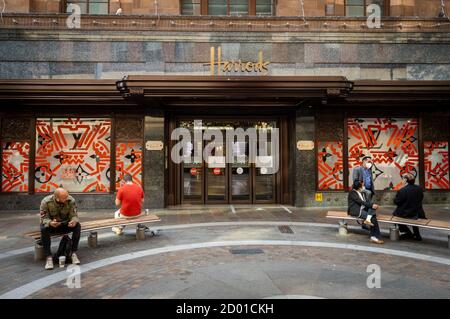 An exterior side view of Harrods department store showing shop window display. Stock Photo