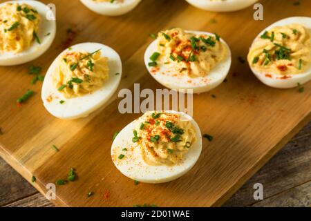 Cooked Organic Hard Boiled Eggs with Chives and Paprika Stock Photo