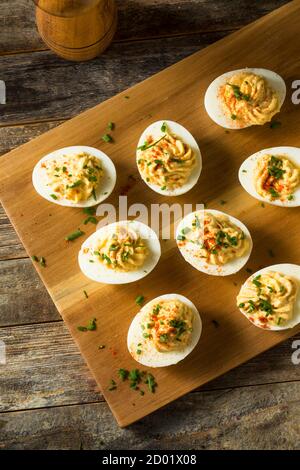 Cooked Organic Hard Boiled Eggs with Chives and Paprika Stock Photo