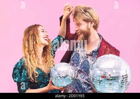 Happy couple celebrating valentines anniversary in disco club - Young trendy people having fun dancing together in nightclub Stock Photo