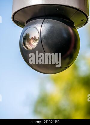 Close up with a security surveillance camera. CCTV camera in a park. Stock Photo