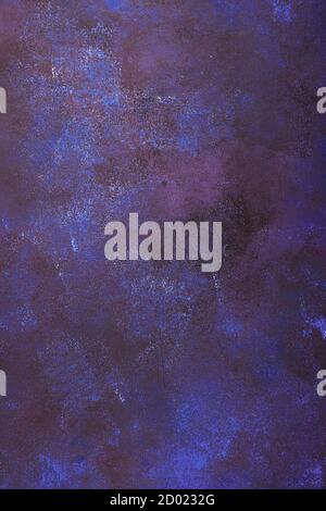 Vertical artificially aged background in dark blue with maroon and white spots. Stock Photo
