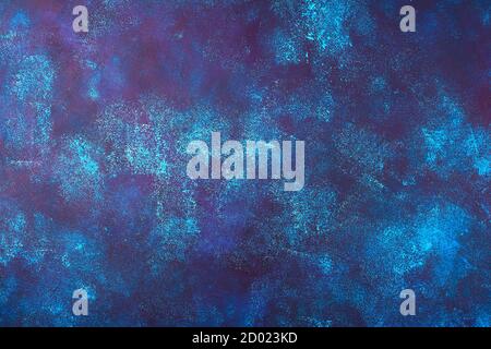 Dark blue concrete background with blue, maroon and white spots. Stock Photo