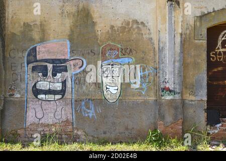 Facade or wall with graffiti paintings on the wall of an abandoned train station in the interior of Brazil, South America Stock Photo