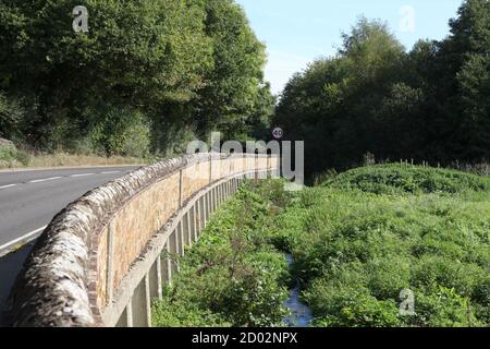 Old walled bridge where A25 Guildford Road passes over the River Tillingbourne in the village of Abinger Hammer, Surrey Hills, Surrey, UK, 2020 Stock Photo