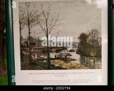 AJAXNETPHOTO. PORT MARLY, FRANCE. - PISSARRO PAINTING - INFORMATION PANEL FOR THE PAINTING BY IMPRESSIONIST PAINTER AND ARTIST CAMILLE PISSARRO ENTITLED 'PORT MARLY, LE LAVOIR, 1872', LOCATED AT THE SPOT ON THE BANKS OF THE RIVER SEINE FROM WHERE THE ARTIST MADE THE PAINTING, THE ARTIST'S ORIGINAL VIEW NOW OBSCURED BY VEGETATION GROWTH.PHOTO:JONATHAN EASTLAND/AJAX REF:G121506 13700 Stock Photo