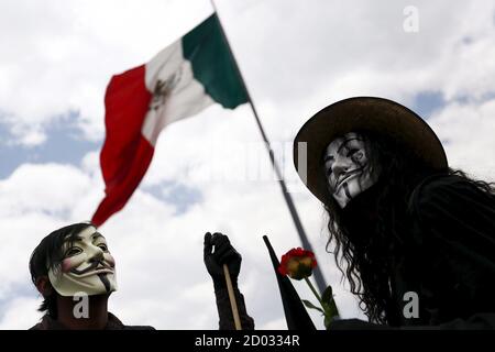 Protesters wearing Guy Fawkes masks take part in a march for Labor Day in Mexico City May 1, 2015. International Workers' Day, also known as Labour Day or May Day, commemorates the struggle of workers in industrialised countries in the 19th century for better working conditions. REUTERS/Edgard Garrido      TPX IMAGES OF THE DAY