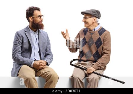 Bearded man and an elderly man sitting on a panel and talking isolated on white background Stock Photo