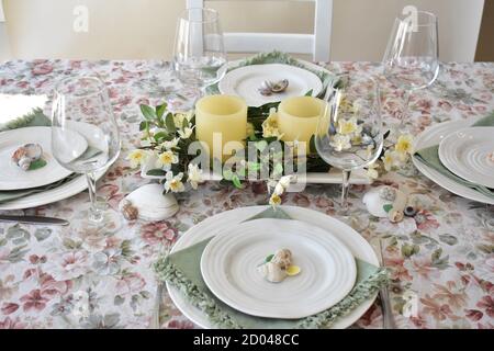 Spring Easter Season table decor with flowers and candles for family dining and celebration events Stock Photo