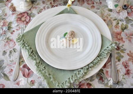 Spring Easter Season table decor with flowers and candles for family dining and celebration events Stock Photo