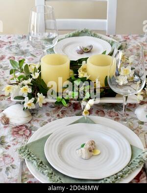 Spring Easter Season table decor with flowers and candles for family dining and celebration events Stock Photo