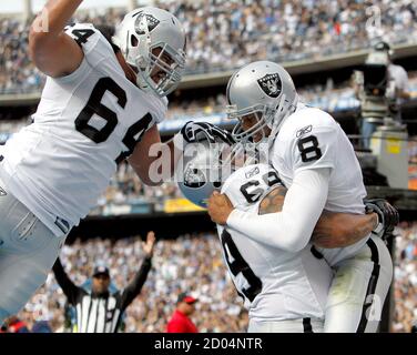 Oakland Raiders Quarterback Jason Campbell 8 Celebrates With Teammates Samson Satele 64 And Khalif Barnes 69 After A Nine Yard Touchdown Run Against The San Diego Chargers During The First Quarter Of Their