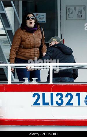 Susy Albertini (L), mother of five-year-old Dayana Arlotti whose body was retrieved on Wednesday from the Costa Concordia cruise ship which ran aground off the west coast of Italy, reacts as she leaves the harbour at Giglio island February 23, 2012. Rescue and search teams returned to the wrecked Costa Concordia on Thursday morning to continue operations to bring up four bodies from the sunken decks of the cruise liner. Divers found eight more bodies on the wreck on Wednesday. REUTERS/Giampiero Sposito (ITALY - Tags: DISASTER TRANSPORT)