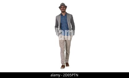Young Asian tourist man wearing hat walking with hands in pockets on white background. Stock Photo