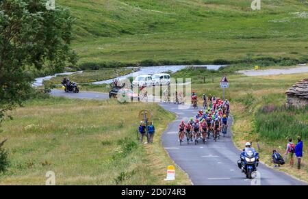 Col de Iseran, France - July 26, 2019: The Peloton climbing the road to Col de Iseran during the stage 19 of Le Tour de France 2019. Stock Photo