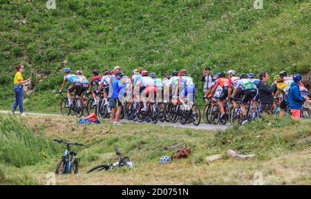 Col de Iseran, France - July 26, 2019: The Peloton climbing the road to Col de Iseran during the stage 19 of Le Tour de France 2019. Stock Photo