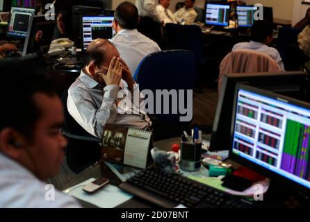 An Indonesian Broker Gestures Near His Monitor At Bank Mandiri Sekuritas Trading Floor In Jakarta August 8 2011 Stocks In Indonesia And Singapore Fell Around 5 Percent On Monday And Other Southeast