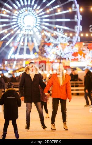 Couple in Love. Romantic Characters for Feast of Saint Valentine. True love. Happy Couple Having Fun at city ice rink in the evening. Happy romantic Stock Photo