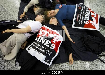 Protesters from the 'The Toronto No Line 9 Network' perform a 'die-in' to demonstrate what they say are the possible effects if the Enbridge operated 'Line 9' petroleum pipeline, which runs under the Finch subway station, ruptured, in Toronto, June 29, 2015.  Enbridge has been seeking permission to reverse the flow of the pipeline that runs from southern Ontario to Montreal. The National Energy Board has ordered Enbridge to conduct hydrostatic testing before they can proceed with the plan, according to local media reports.  REUTERS/Mark Blinch