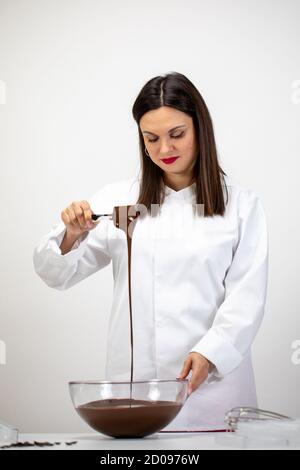 handmade chocolate Candy manufacturing. chocolatier makes handmade chocolate Stock Photo