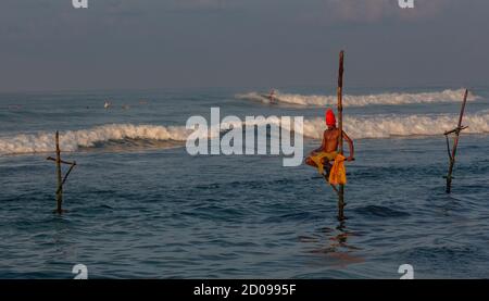Galle, Sri Lanka - 2019-04-01 - Stilt Fishermen of Sri Lanka Spend All Day on Small Platforms to Catch Fish for Dinner. Stock Photo