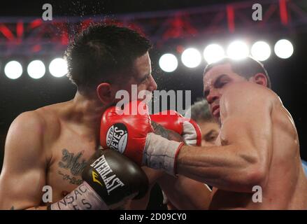 Former lightweight champion boxer Brandon Rios (L) of the U.S. takes a punch from Richard Abril of Cuba during a fight for the vacant WBA lightweight title at the Mandalay Bay Events Center in Las Vegas, Nevada April 14, 2012. Rios won the 12-round fight by split decision but does not receive the title because he was overweight at the official weigh-in. REUTERS/Las Vegas Sun/Steve Marcus (UNITED STATES - Tags: SPORT BOXING)