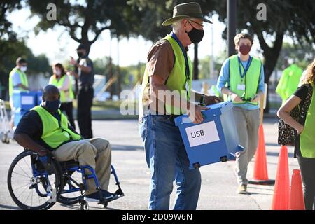 Austin, Texas, USA. 2nd Oct 2020. Travis County elections officials collect boxes with mail-in ballots dropped off by voters in person as voting starts in Texas for the contentious presidential contest as well as other races. Credit: Bob Daemmrich/Alamy Live News Stock Photo