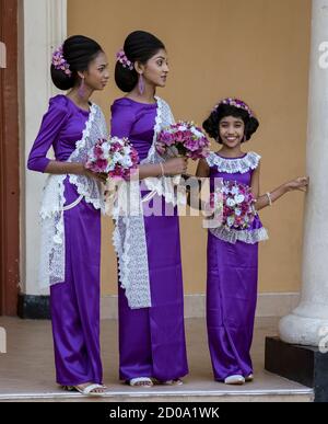 Kandy, Sri Lanka - 09-03-24 - Two Women and Girl Wait for Wedding Couple.