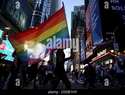 New York, United States. 02nd Oct, 2020. Protesters hold rainbow flags as they march on Seventh Avenue at The People's March for Roxanne Moore Protest in New York City on Friday, October 2, 2020. Roxanne Moore a 29-year-old Black transgender woman from Reading, Pennsylvania was shot 16 times by police officers. Photo by John Angelillo/UPI Credit: UPI/Alamy Live News Stock Photo