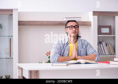 Male student preparing for exam at home Stock Photo