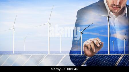 Double exposure graphic of business people working over wind turbine farm and green renewable energy worker interface. Concept of sustainability Stock Photo
