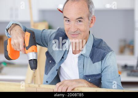 man drilling wood at home Stock Photo