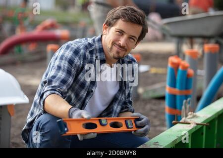 workman using spirit level on construction site Stock Photo