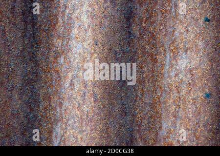 Abstract red texture background on tin metal sheet with rust patterns, close up view. Stock Photo