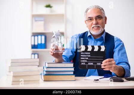 Old male author writing the screenplay Stock Photo