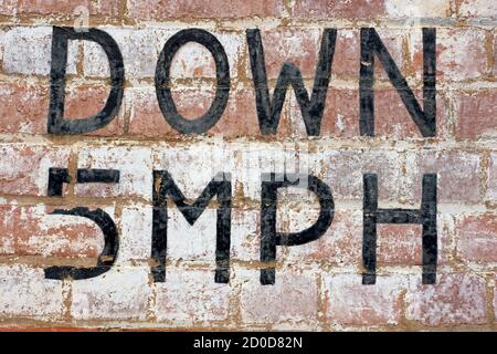 Old brick wall texture with black graphic lettering and abstract typography alphabet. Stock Photo