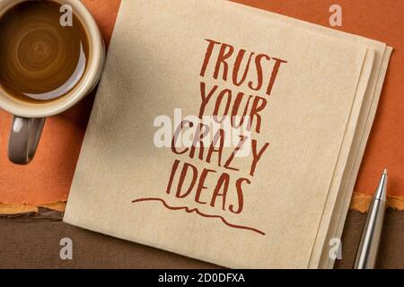trust your crazy ideas inspirational note - handwriting on a napkin with coffee, creativity, confidence  and personal development concept Stock Photo