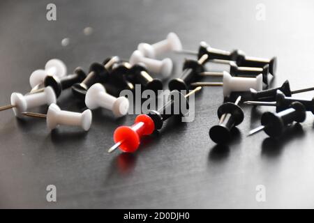 colorful punch pins drawing pins on black background Stock Photo